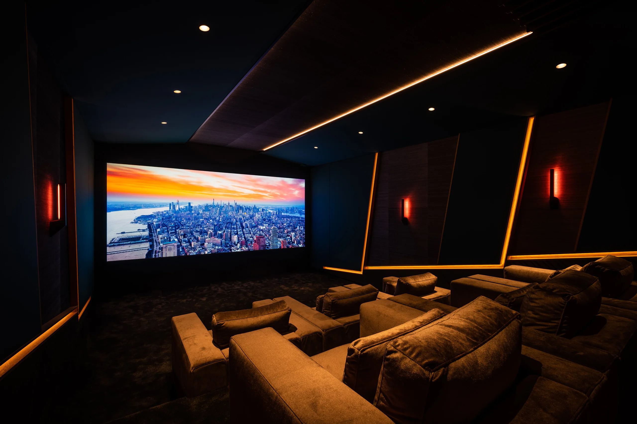 Finished six-seat JBL Synthesis cinema with warm linear lighting and upholstered lounge seating