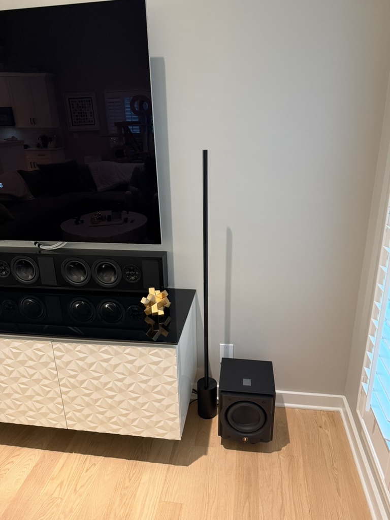 Finished living-room detail with the subwoofer and LCR installation