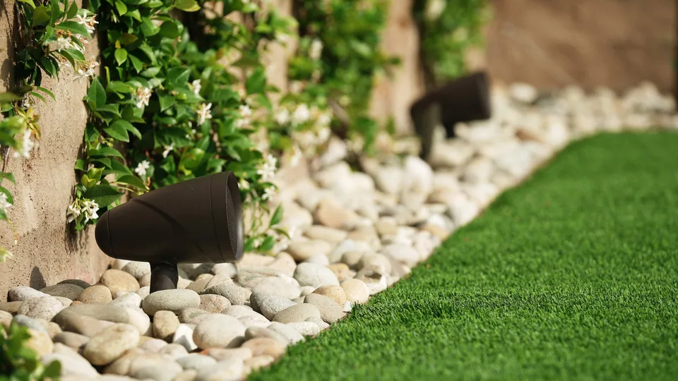 Landscaped garden illustrating discreet Sonance outdoor speaker placement